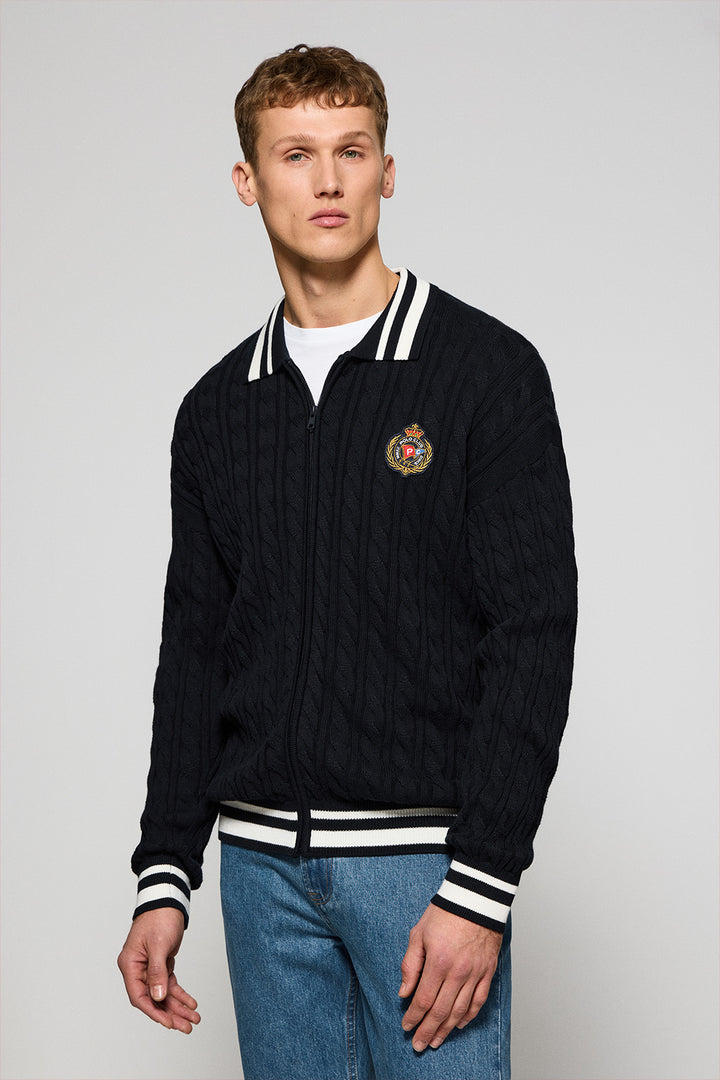 Navy-blue cable-knit cardigan with zip and nautical logo