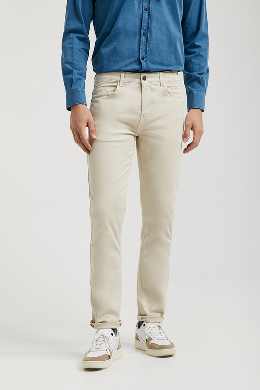 Beige trousers with five pockets and embroidered logo